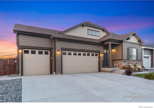 5524 Congressional Ct, Windsor, CO 80528 - view of front of home featuring concrete driveway, a garage, fence, and a shingled roof
