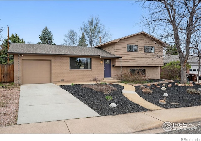 4035 Darley Ave, Boulder, CO 80305 - split level home with brick siding, an attached garage, driveway, and fence