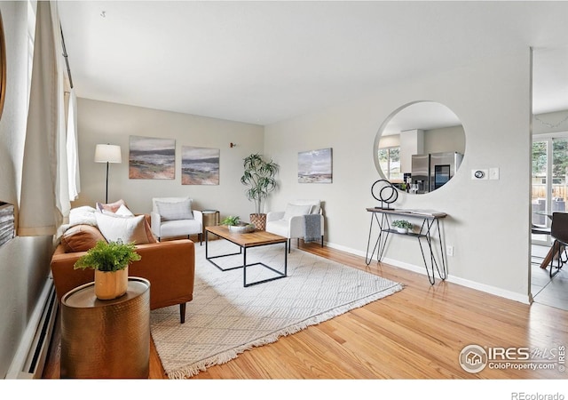 4035 Darley Ave, Boulder, CO 80305 - living area featuring baseboard heating, wood finished floors, and baseboards