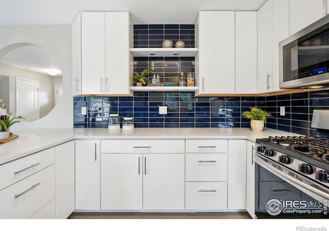 4035 Darley Ave, Boulder, CO 80305 - kitchen featuring appliances with stainless steel finishes, open shelves, decorative backsplash, and white cabinetry