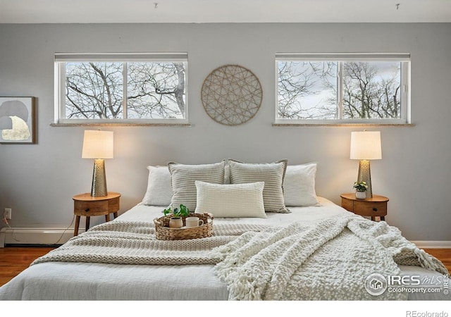 4035 Darley Ave, Boulder, CO 80305 - bedroom with multiple windows, a baseboard heating unit, and wood finished floors