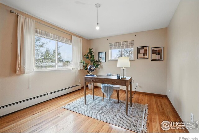 4035 Darley Ave, Boulder, CO 80305 - home office featuring a baseboard heating unit, wood finished floors, and baseboards