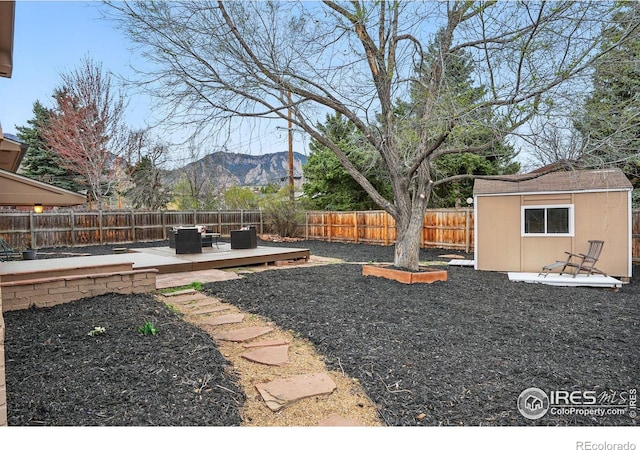 4035 Darley Ave, Boulder, CO 80305 - fenced backyard with a deck with mountain view, an outdoor structure, and a storage unit