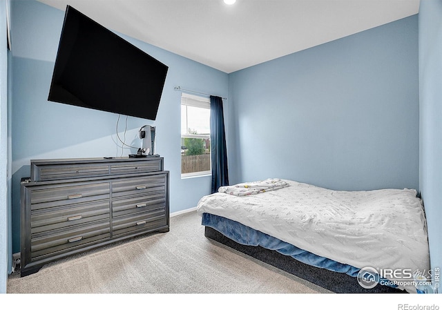 bedroom with carpet flooring and baseboards