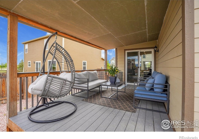 wooden deck with an outdoor living space