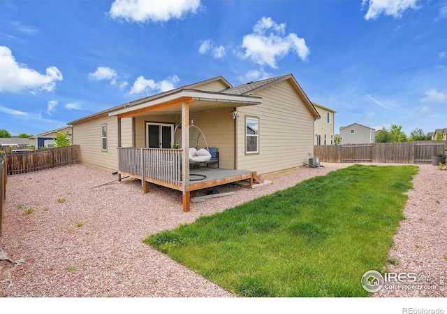 rear view of property with a wooden deck and central AC