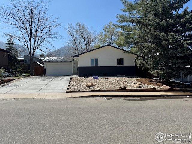1225 Ithaca Dr, Boulder, CO 80305 - view of front of house with concrete driveway and a garage