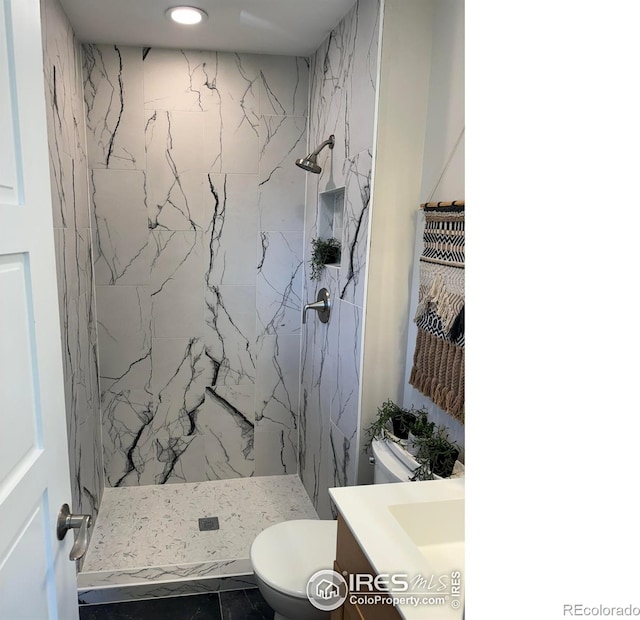 1225 Ithaca Dr, Boulder, CO 80305 - bathroom featuring toilet, a marble finish shower, recessed lighting, and vanity