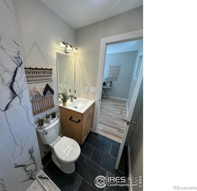 1225 Ithaca Dr, Boulder, CO 80305 - bathroom with vanity, toilet, and marble finish flooring