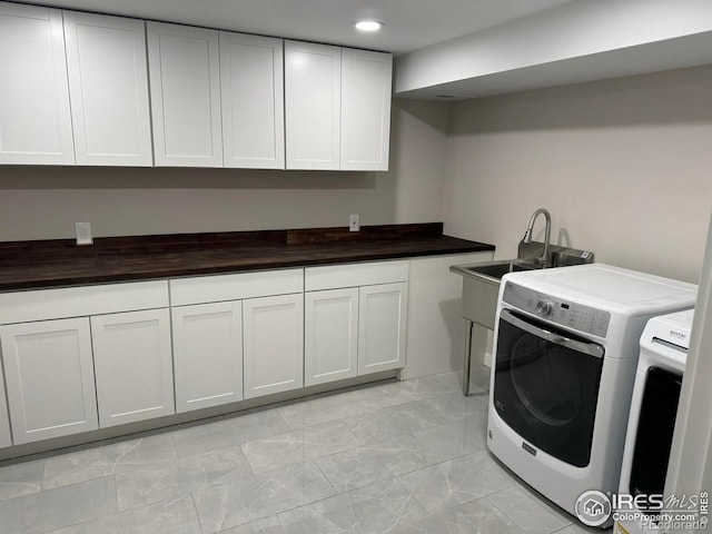 1225 Ithaca Dr, Boulder, CO 80305 - laundry area with washing machine and dryer, cabinet space, light marble finish floors, and recessed lighting
