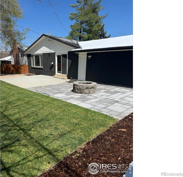 1225 Ithaca Dr, Boulder, CO 80305 - view of front of home with a patio area and an outdoor fire pit