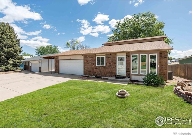 316 43rd Avenue Ct, Greeley, CO 80634 - ranch-style home with concrete driveway, a garage, brick siding, and central air condition unit