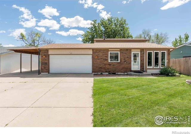 316 43rd Avenue Ct, Greeley, CO 80634 - ranch-style home with concrete driveway, brick siding, a garage, and a carport