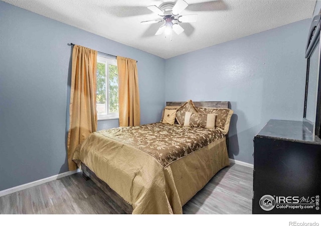 316 43rd Avenue Ct, Greeley, CO 80634 - bedroom with wood finished floors, baseboards, a ceiling fan, and a textured ceiling