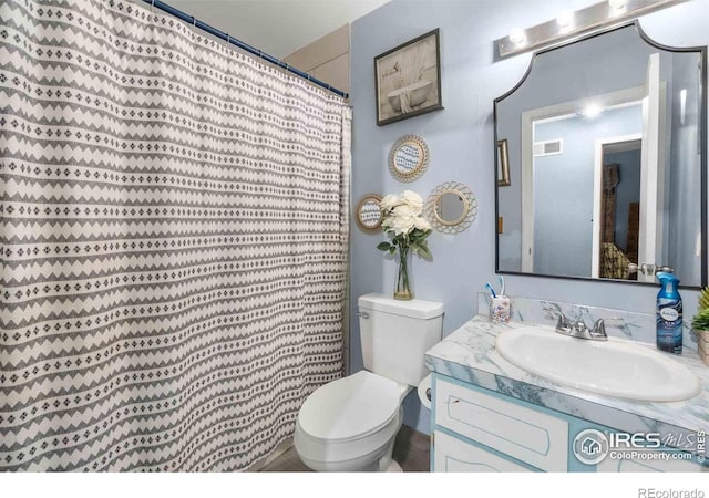 316 43rd Avenue Ct, Greeley, CO 80634 - full bathroom featuring toilet, vanity, and a shower with shower curtain