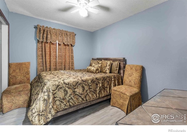 316 43rd Avenue Ct, Greeley, CO 80634 - bedroom featuring wood finished floors, a textured ceiling, and a ceiling fan
