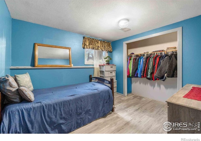 316 43rd Avenue Ct, Greeley, CO 80634 - bedroom featuring a closet, wood finished floors, and a textured ceiling