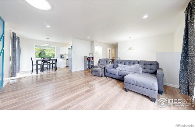2648 Bradbury Ct, Fort Collins, CO 80521 - living room featuring light wood finished floors, a chandelier, recessed lighting, and baseboards