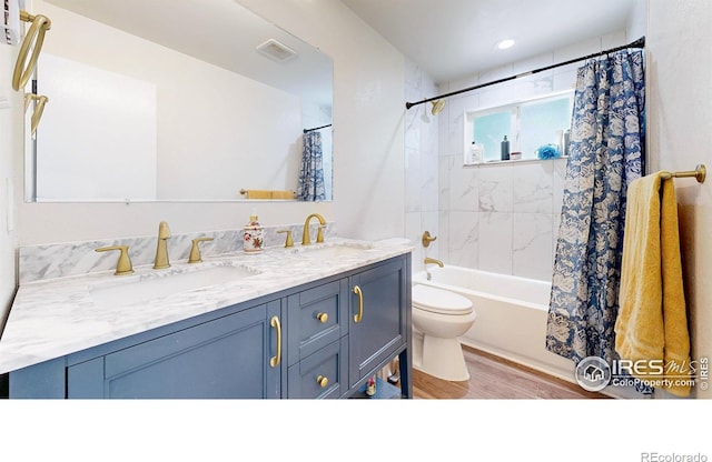2648 Bradbury Ct, Fort Collins, CO 80521 - bathroom featuring toilet, wood finished floors, double vanity, and shower / tub combo with curtain