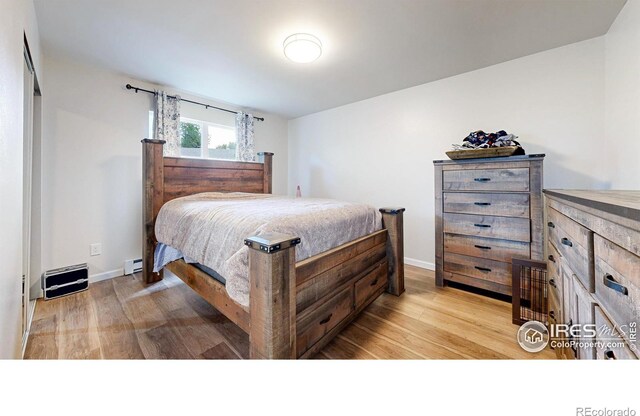 2648 Bradbury Ct, Fort Collins, CO 80521 - bedroom featuring light wood-style floors, a baseboard radiator, and baseboards
