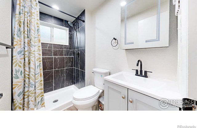 2648 Bradbury Ct, Fort Collins, CO 80521 - bathroom with toilet, vanity, a tile shower, and a textured wall