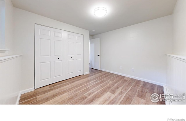 2648 Bradbury Ct, Fort Collins, CO 80521 - unfurnished bedroom featuring light wood-type flooring, a closet, and baseboards