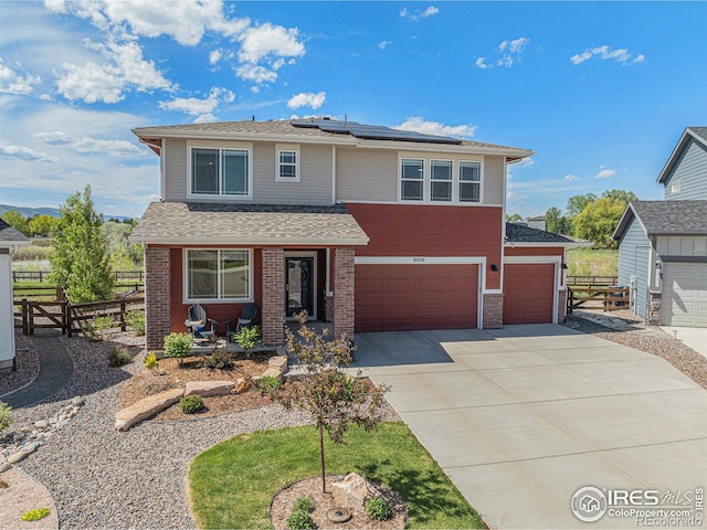 6009 Autumn Breeze Ct, Fort Collins, CO 80528 - view of front facade featuring fence, roof mounted solar panels, concrete driveway, a porch, and a shingled roof