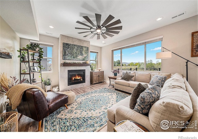 6009 Autumn Breeze Ct, Fort Collins, CO 80528 - living area featuring ceiling fan, wood finished floors, a tile fireplace, recessed lighting, and baseboards