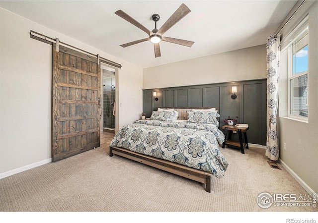 6009 Autumn Breeze Ct, Fort Collins, CO 80528 - bedroom with light carpet, a barn door, and ceiling fan