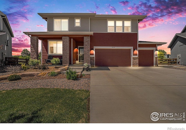 6009 Autumn Breeze Ct, Fort Collins, CO 80528 - view of front of property with a porch, concrete driveway, stone siding, fence, and a garage