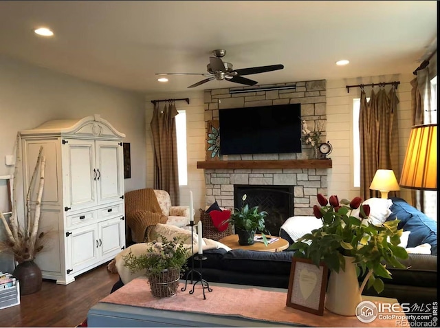 8241 White Owl Ct, Windsor, CO 80550 - living room featuring ceiling fan, dark wood-style floors, recessed lighting, a stone fireplace, and healthy amount of natural light