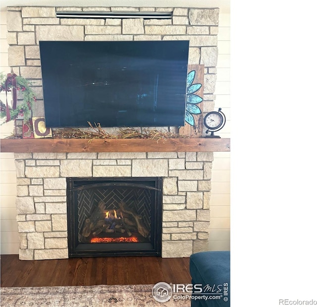 8241 White Owl Ct, Windsor, CO 80550 - detailed view of a fireplace and wood finished floors