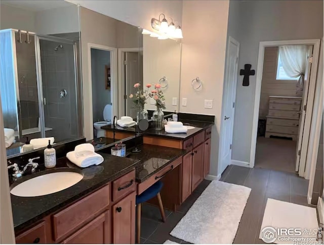 8241 White Owl Ct, Windsor, CO 80550 - bathroom with vanity, a shower stall, and tile patterned flooring