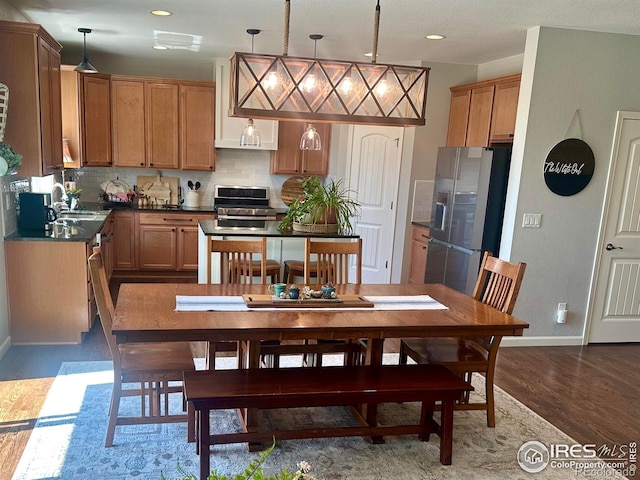8241 White Owl Ct, Windsor, CO 80550 - dining space featuring dark wood finished floors and recessed lighting