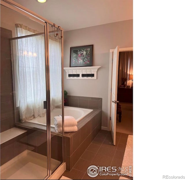8241 White Owl Ct, Windsor, CO 80550 - full bathroom featuring a garden tub, a shower stall, and tile patterned flooring