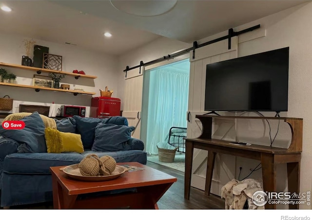 8241 White Owl Ct, Windsor, CO 80550 - living area featuring a barn door, wood finished floors, and recessed lighting
