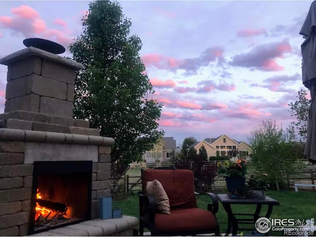 8241 White Owl Ct, Windsor, CO 80550 - yard at dusk with a lit fireplace