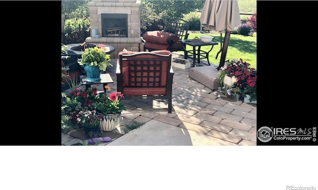 8241 White Owl Ct, Windsor, CO 80550 - view of patio / terrace featuring an outdoor living space with a fireplace