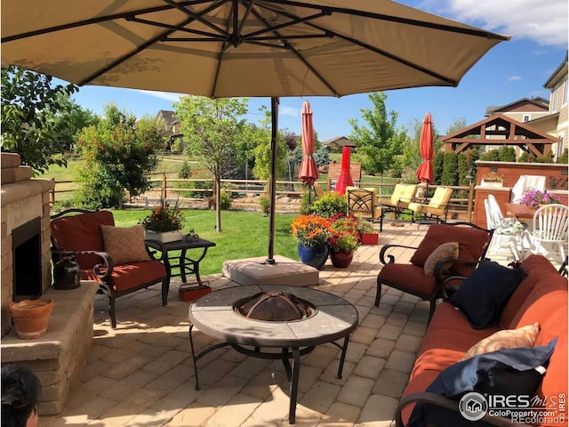 8241 White Owl Ct, Windsor, CO 80550 - view of patio / terrace featuring an outdoor living space with a fire pit