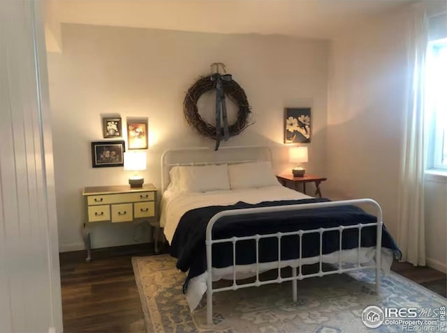 8241 White Owl Ct, Windsor, CO 80550 - bedroom featuring wood finished floors and multiple windows