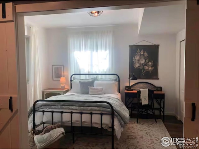 8241 White Owl Ct, Windsor, CO 80550 - bedroom with wood finished floors