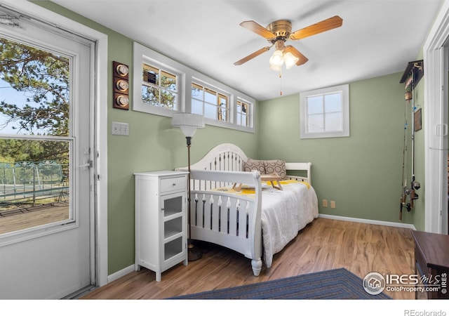 885 County Road 67j, Red Feather Lakes, CO 80545 - bedroom featuring wood finished floors, baseboards, and multiple windows