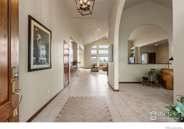 7717 Amour Hill Dr, Greeley, CO 80634 - foyer entrance featuring light tile patterned floors, lofted ceiling, recessed lighting, and baseboards