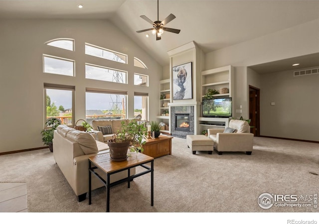 7717 Amour Hill Dr, Greeley, CO 80634 - carpeted living room with ceiling fan, a high end fireplace, high vaulted ceiling, built in shelves, and baseboards