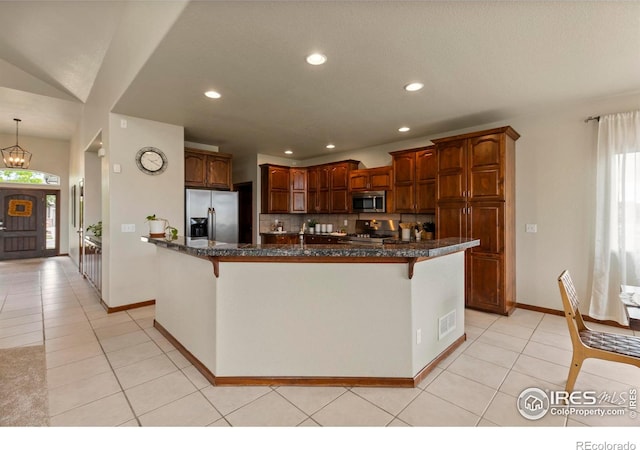 7717 Amour Hill Dr, Greeley, CO 80634 - kitchen with stainless steel appliances, a breakfast bar area, light tile patterned flooring, recessed lighting, and baseboards