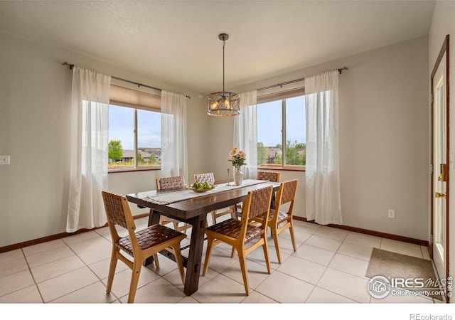 7717 Amour Hill Dr, Greeley, CO 80634 - dining area with plenty of natural light, a chandelier, baseboards, and light tile patterned floors