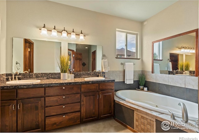 7717 Amour Hill Dr, Greeley, CO 80634 - bathroom with a tub with jets, double vanity, and tile patterned flooring