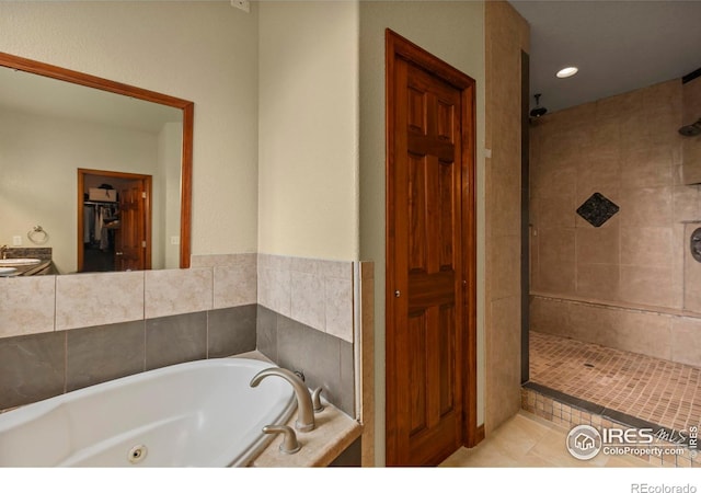 7717 Amour Hill Dr, Greeley, CO 80634 - bathroom featuring a stall shower, a sink, a tub with jets, and tile patterned floors