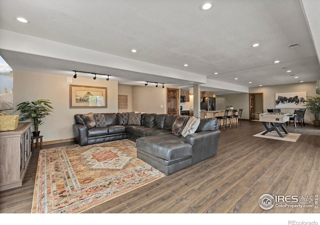 7717 Amour Hill Dr, Greeley, CO 80634 - living room with wood finished floors, baseboards, track lighting, recessed lighting, and a textured ceiling