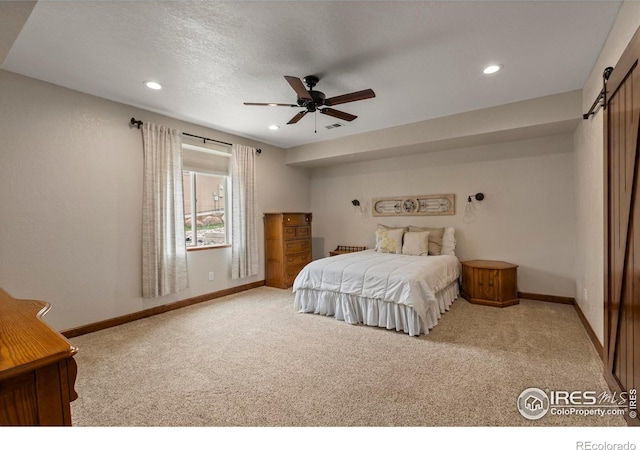 7717 Amour Hill Dr, Greeley, CO 80634 - bedroom featuring a barn door, carpet flooring, baseboards, recessed lighting, and ceiling fan